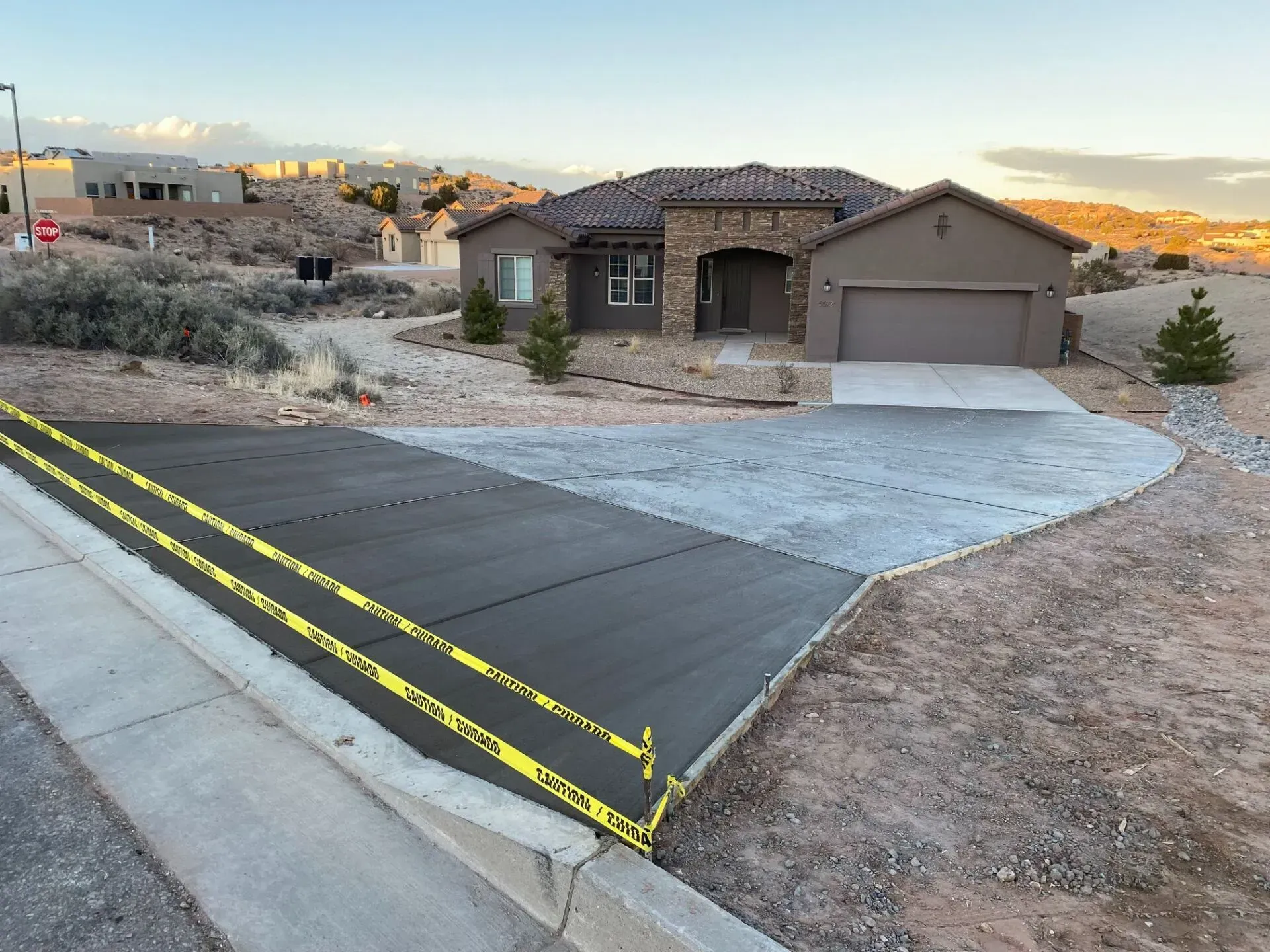 A concrete driveway is being built in front of a house