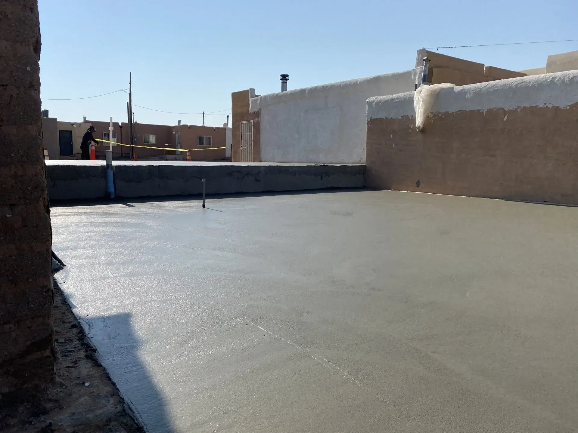 A concrete floor with a building in the background