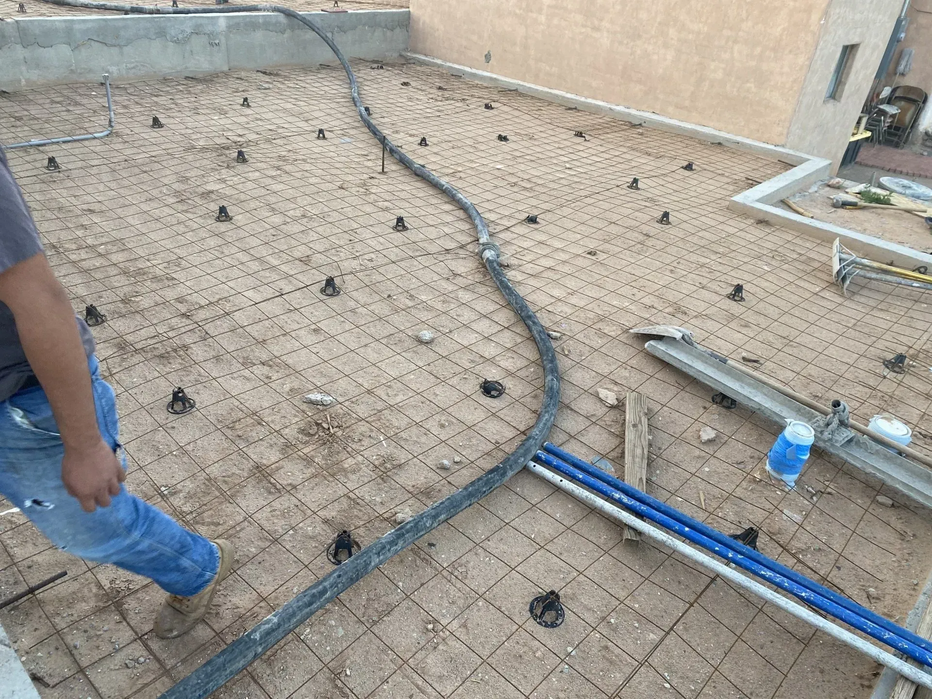 A man is standing on top of a concrete floor.