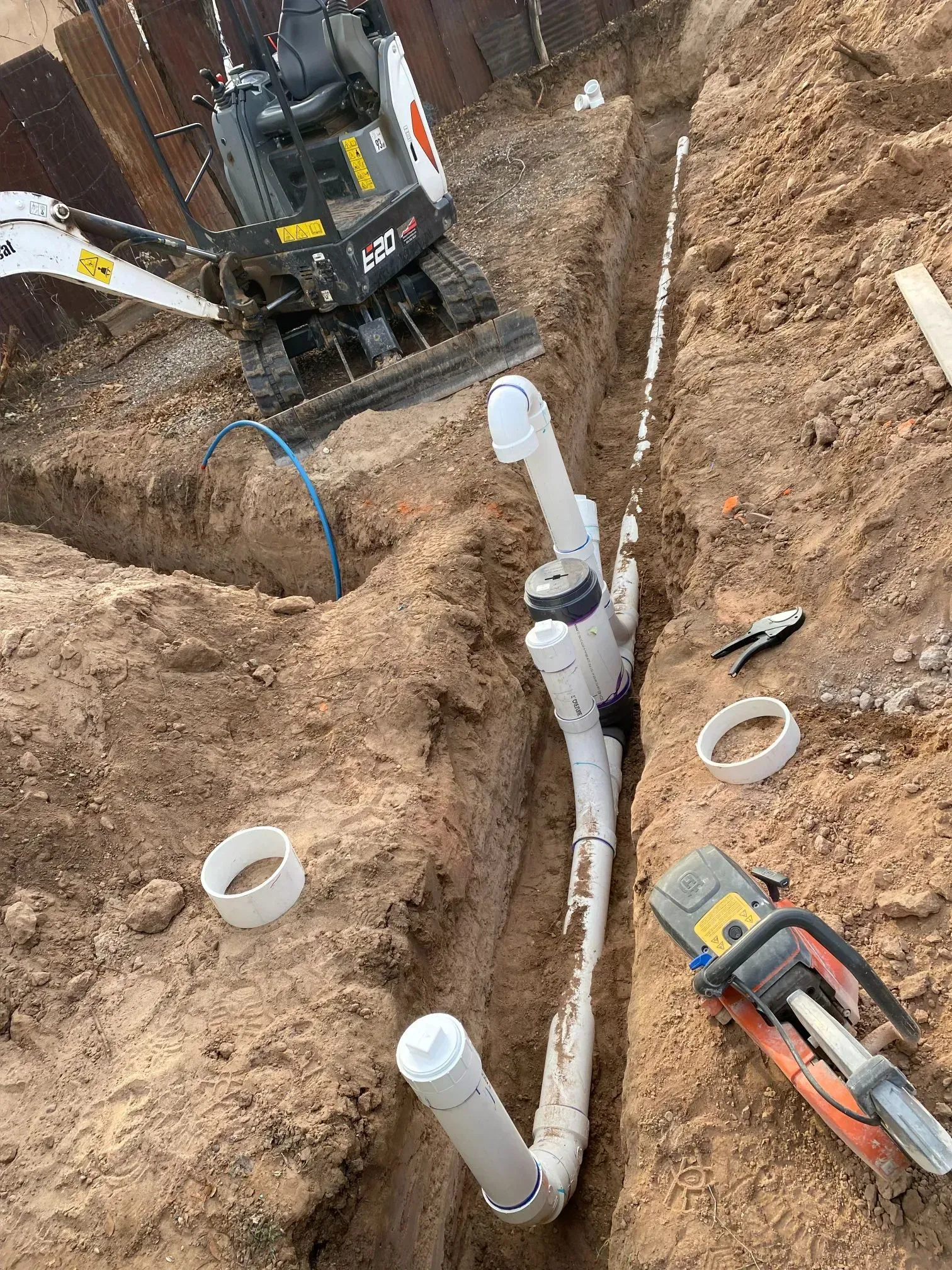 A pipe is being installed in a hole in the ground.