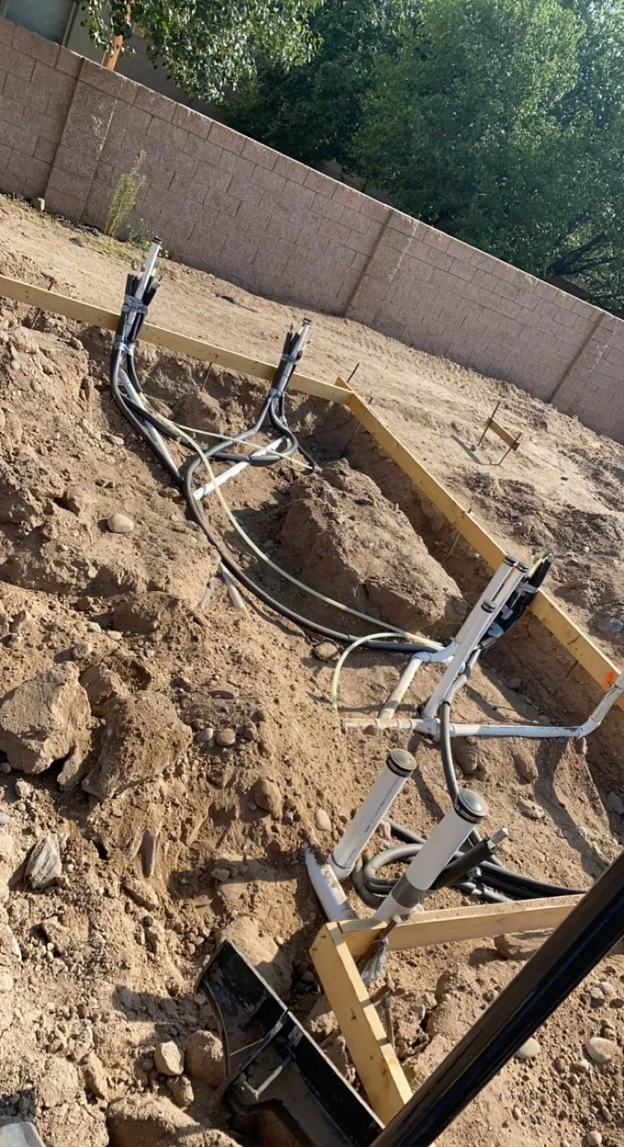 A piece of equipment is laying in the dirt in a field.