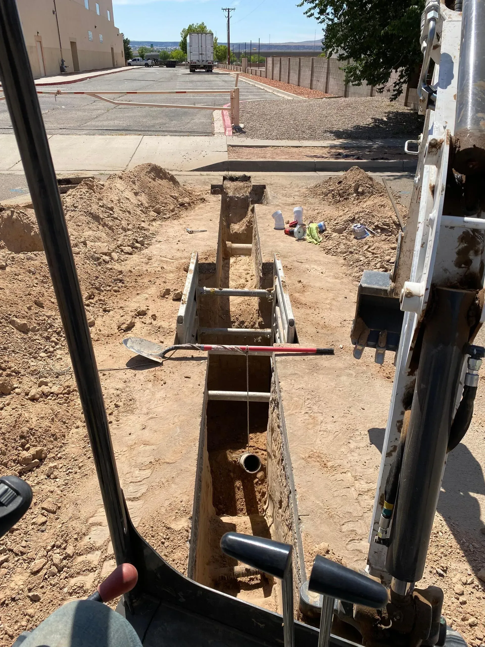 A person is using a shovel to dig a hole in the ground