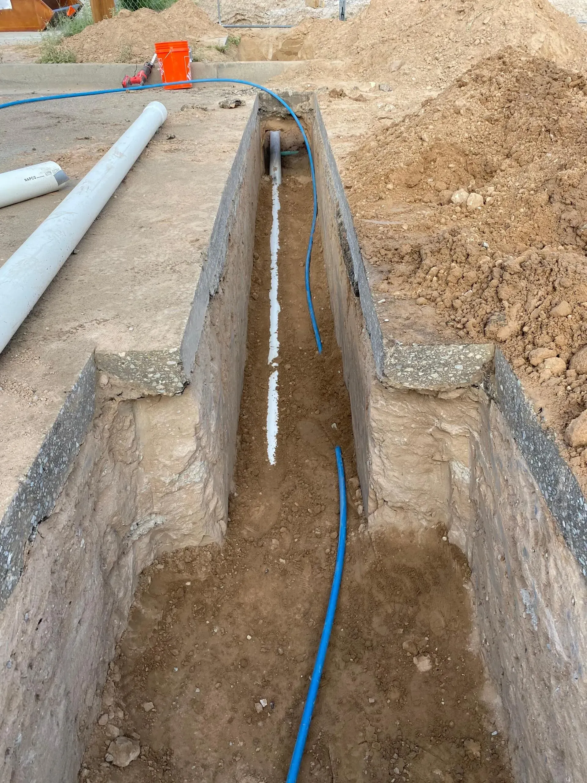 A hole in the ground with a pipe in it