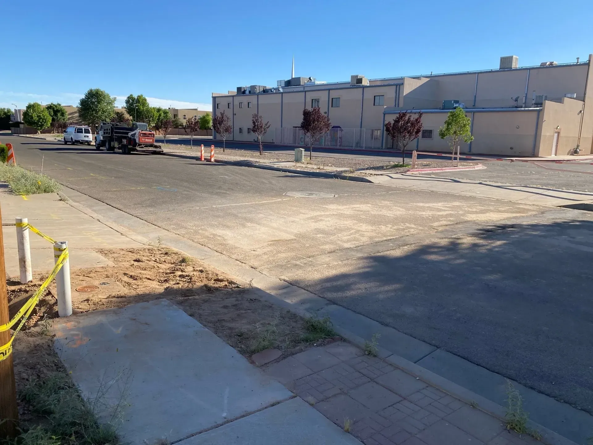 An empty street with a building in the background