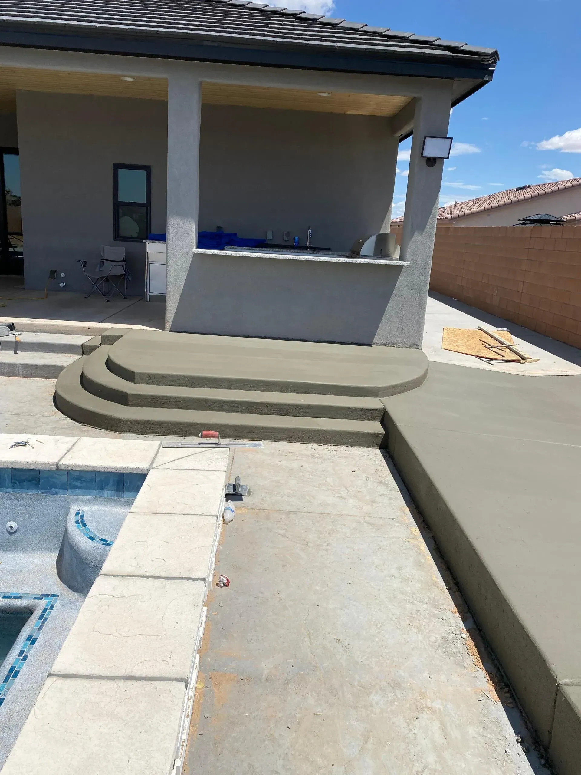 A house is being built next to a swimming pool