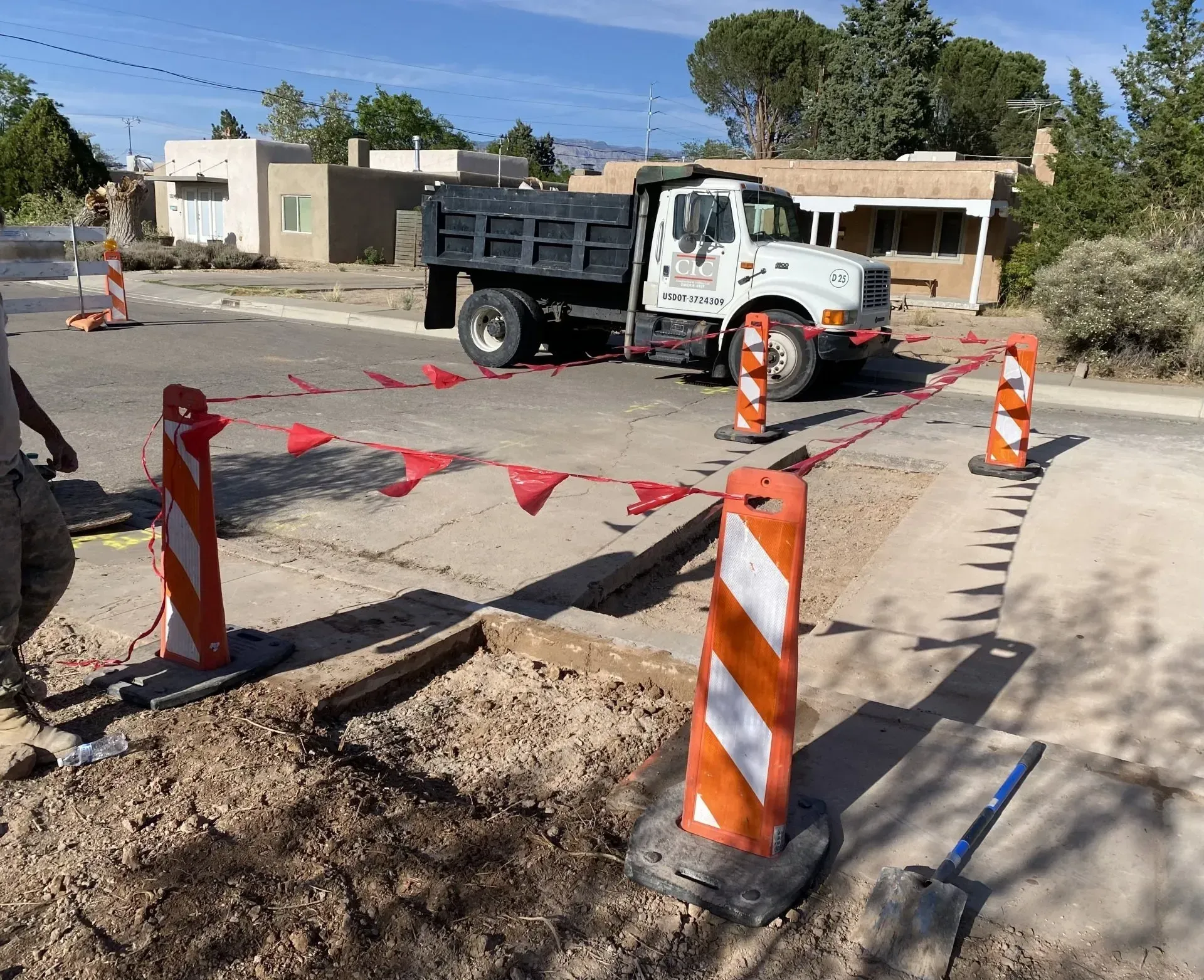 A dump truck is parked on the side of the road
