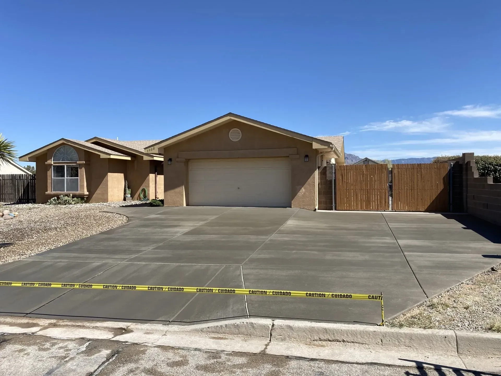A house with a concrete driveway in front of it