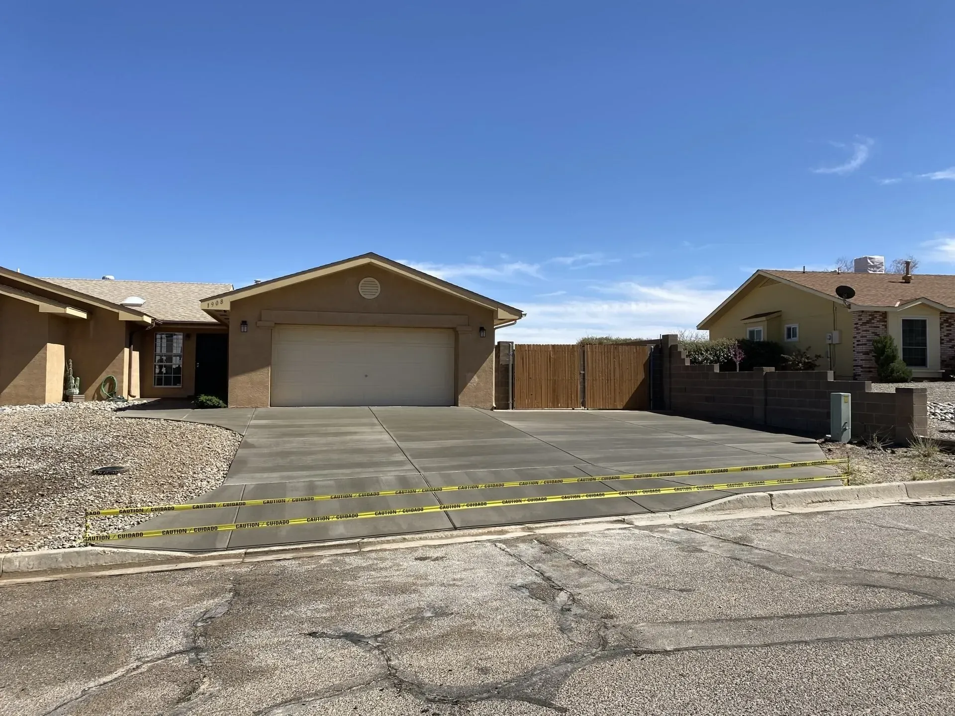 A house with a garage and a driveway in front of it.