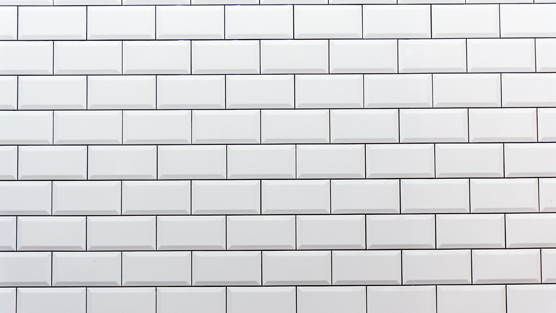 A kitchen with white cabinets , granite counter tops , stainless steel appliances and a sink.