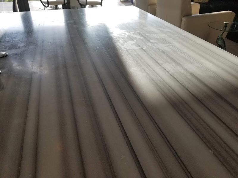 A close up of a wooden table with a striped pattern