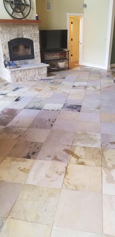 A living room with a tiled floor and a fireplace.