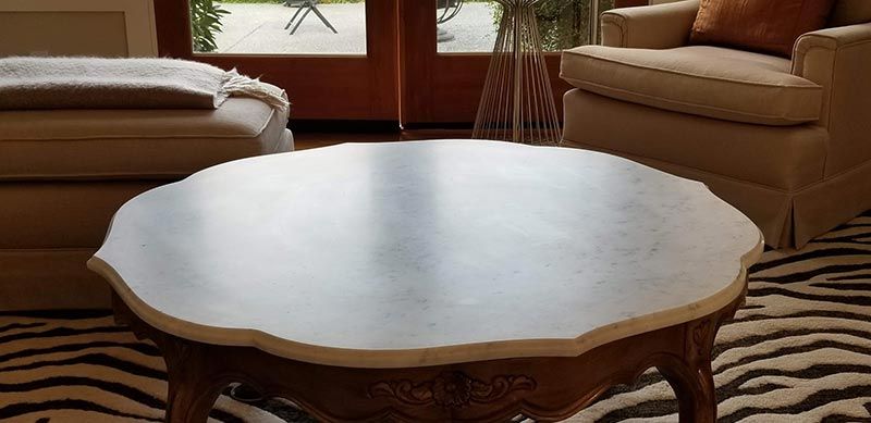 A kitchen with granite counter tops , stainless steel appliances , and wooden cabinets.