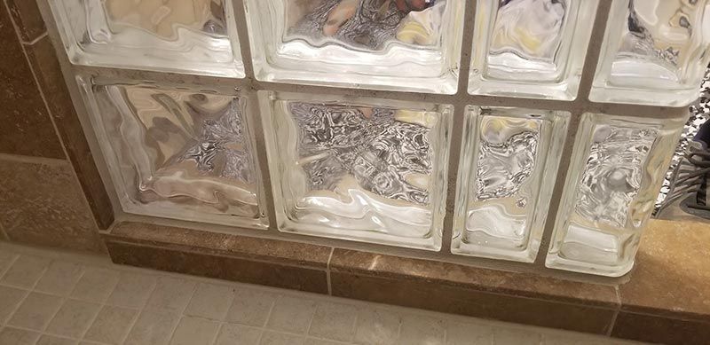 A vacuum cleaner is cleaning a tiled floor.