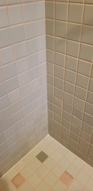 A kitchen with white cabinets , stainless steel appliances , and granite counter tops.