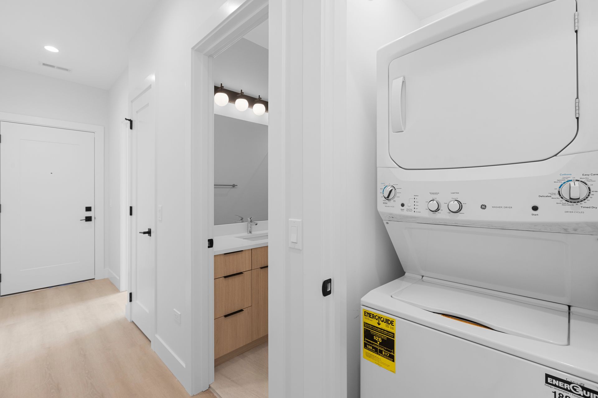 A washer and dryer are stacked on top of each other in a laundry room.