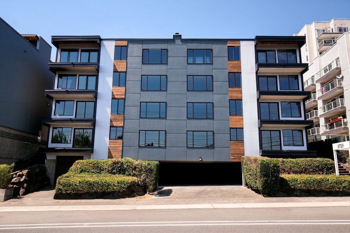 A large apartment building with a garage underneath it