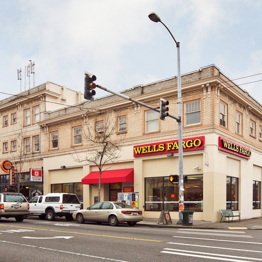 A wells fargo store on the corner of a street