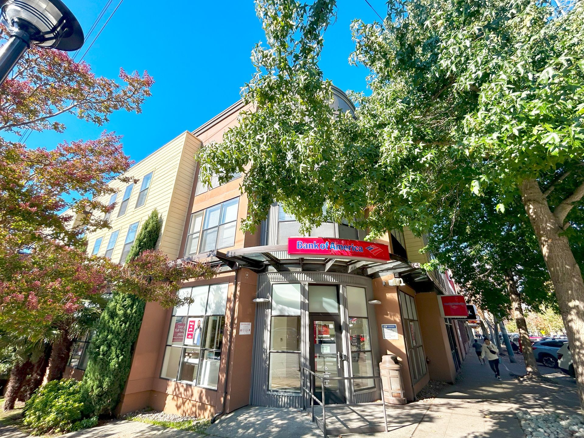 A large building with a lot of windows and trees in front of it.