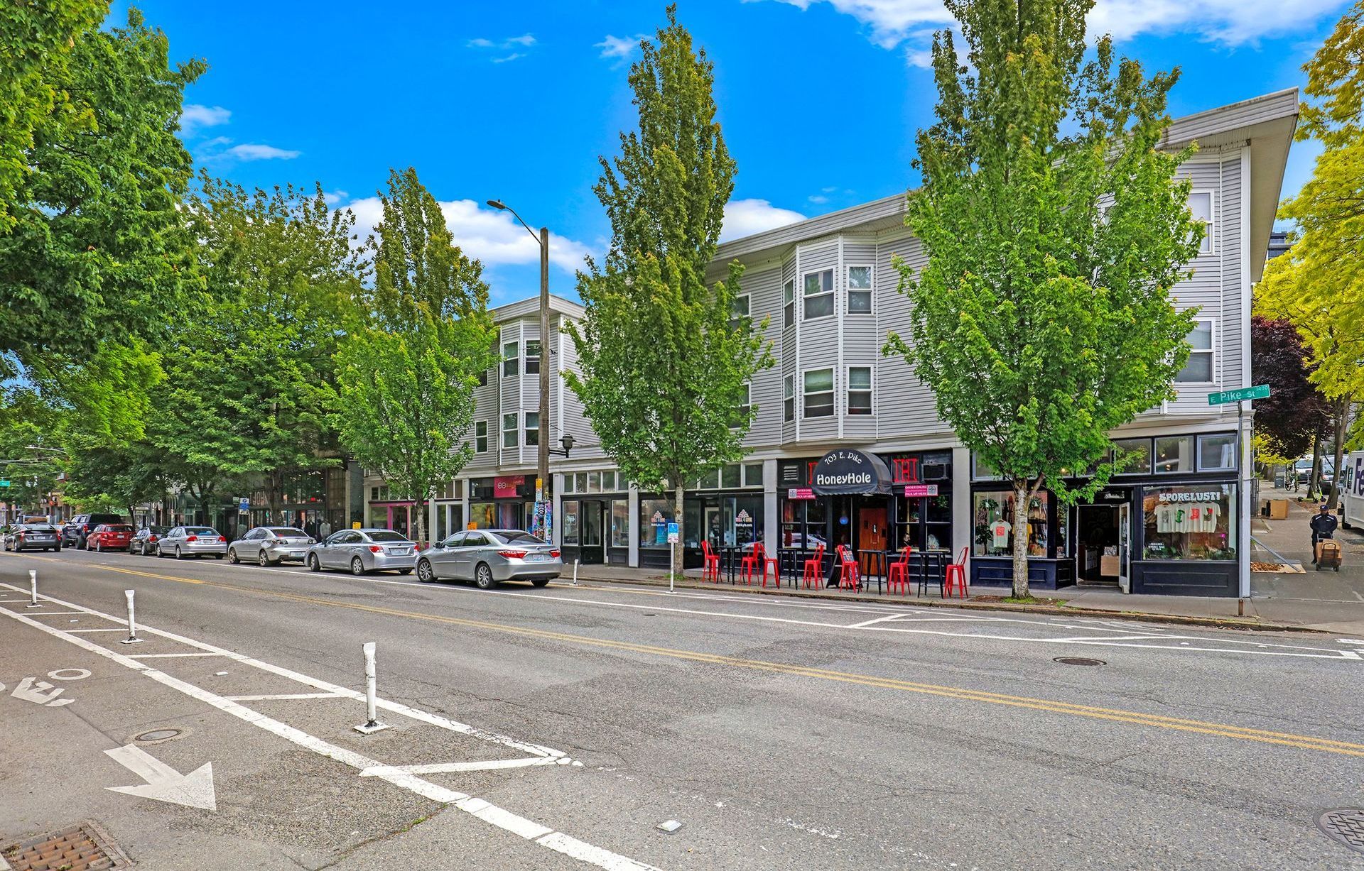 A row of shops are lined up on the side of a city street.
