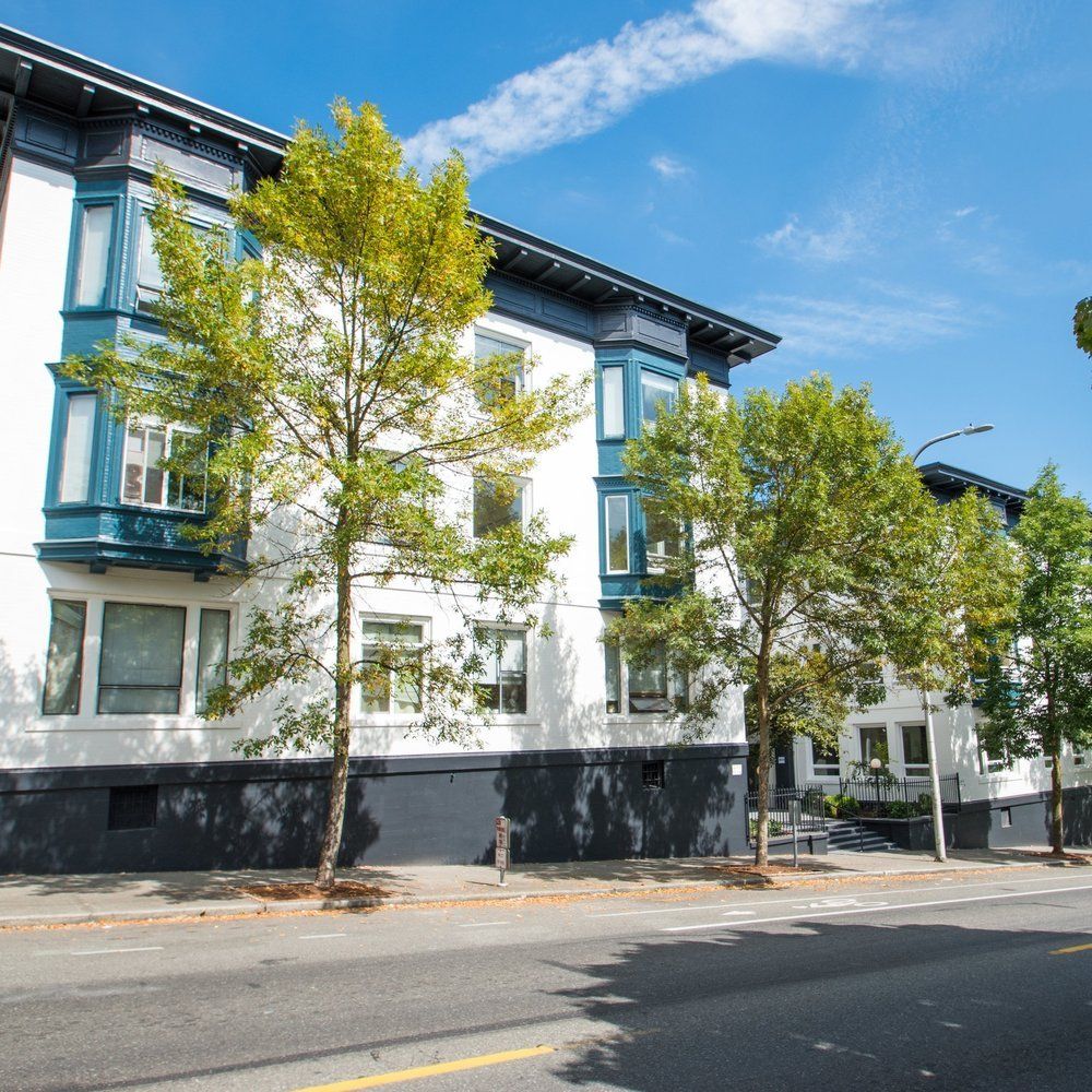 A building with a lot of windows and trees in front of it
