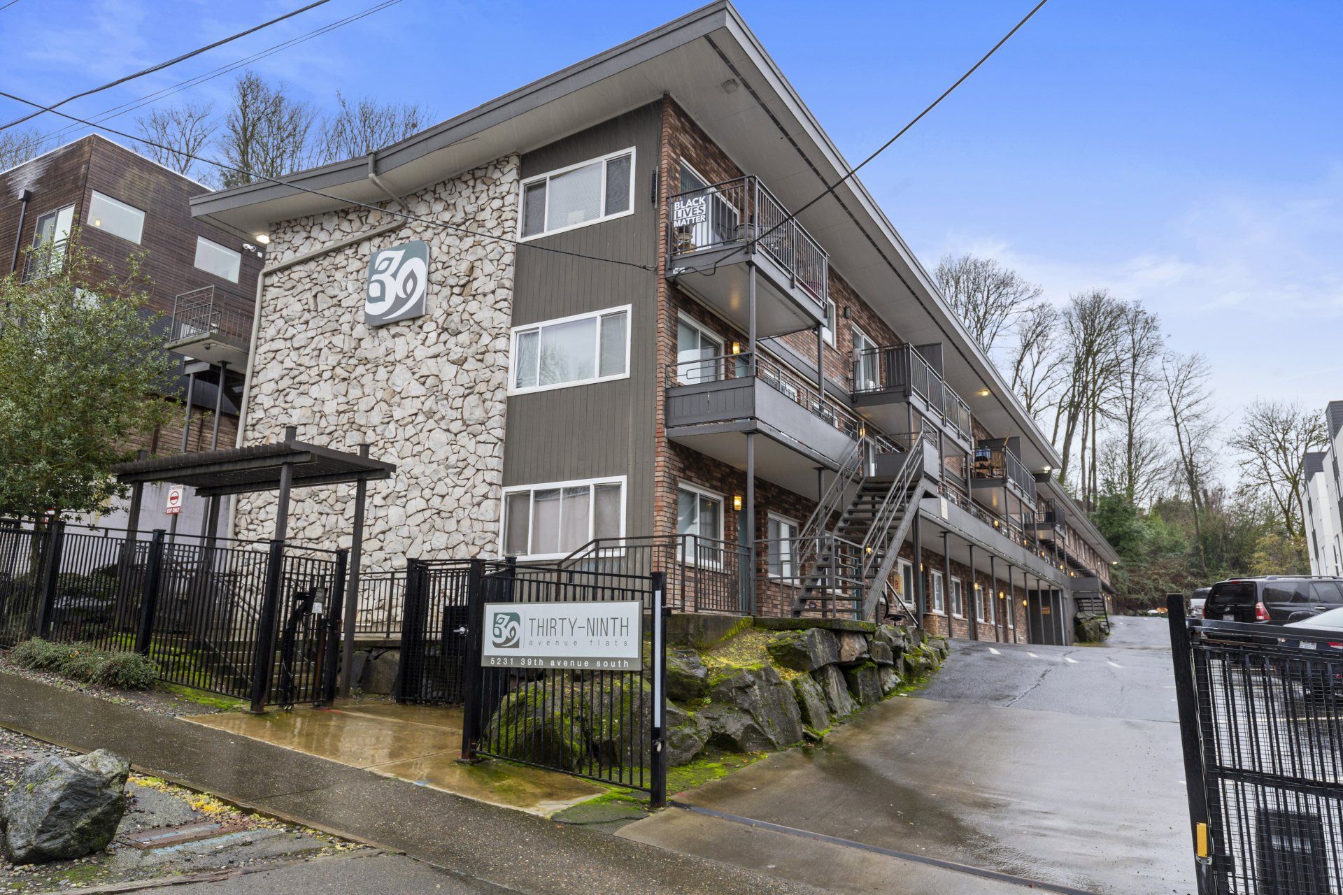 A large apartment building with stairs leading up to the second floor.