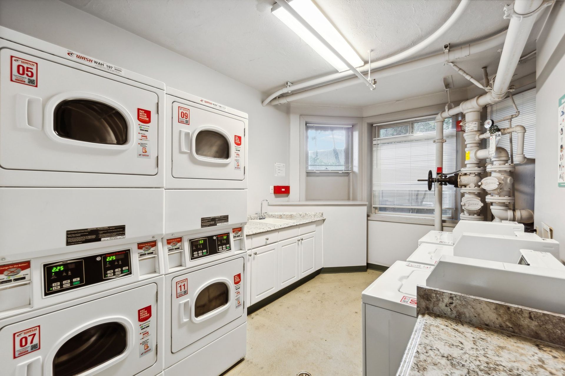 A laundromat with a lot of washers and dryers