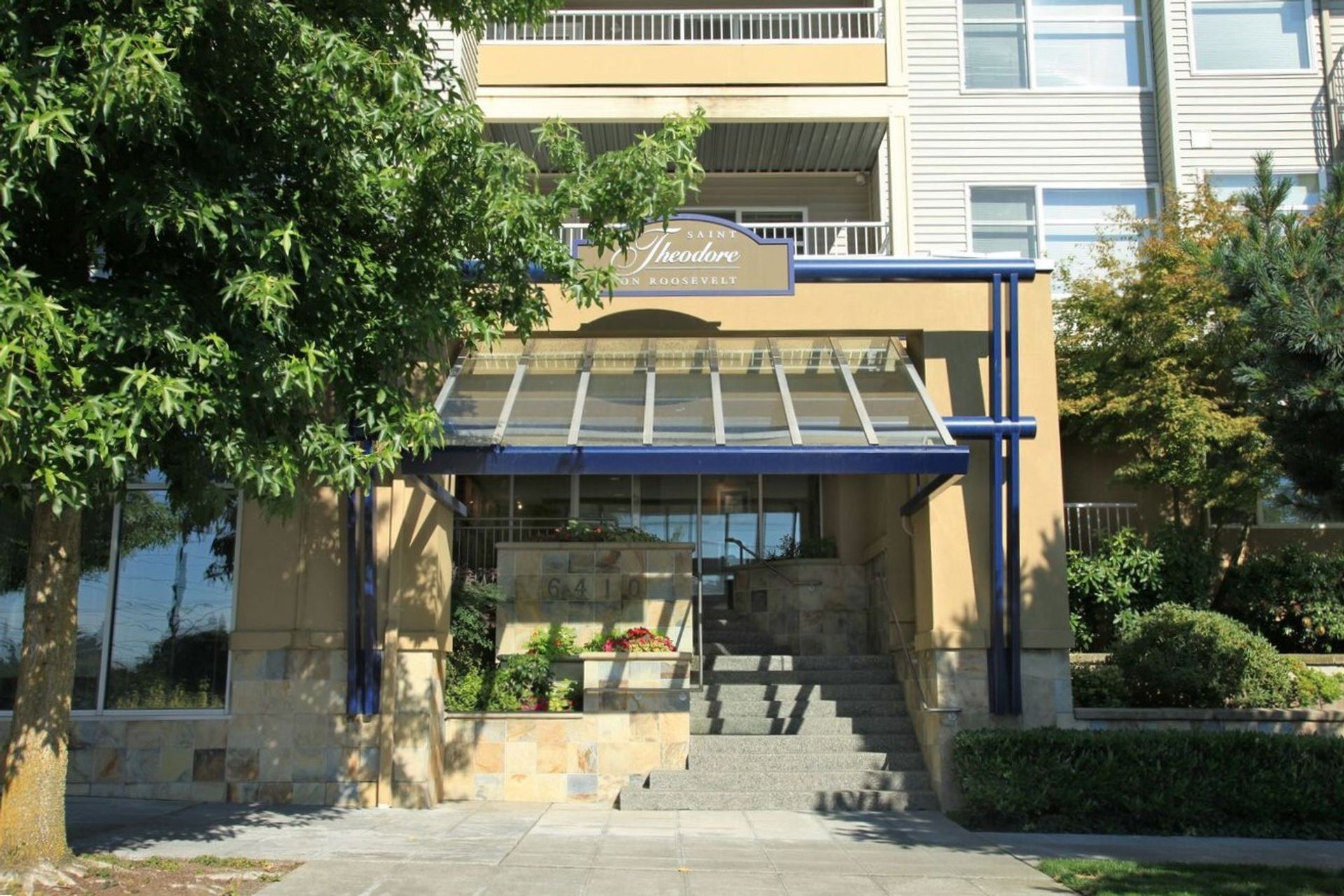 A building with a blue awning and stairs leading up to it