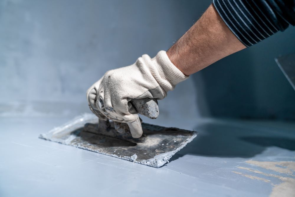Man Applying Waterproofing On The Wall And Flooring — Bananacoast Waterproofing in Korora, NSW