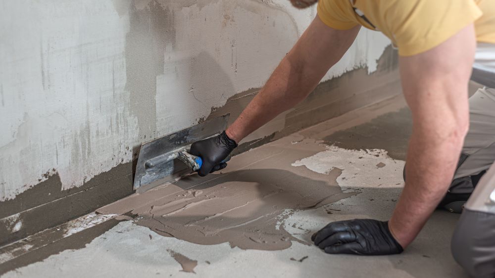Applying A Liquid Membrane By Hand With A Trowel — Bananacoast Waterproofing in Bellingen, NSW
