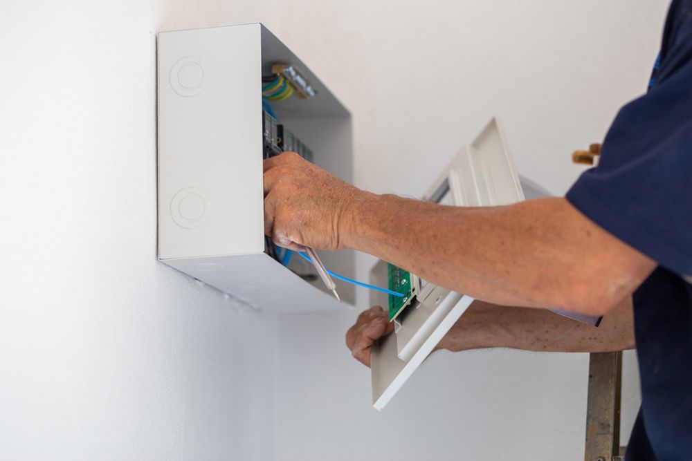 Electrician Installing The Electric Panel Board — Trusted Electricians in Nowra, NSW