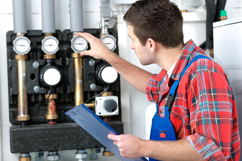 Man Checking The Water Heater Pressure — Electrical Contractor in Shoalhaven, NSW