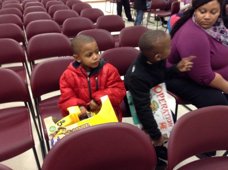 Two Boys Holding Their New Toys