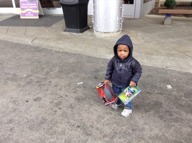 Little Boy Holding Toys