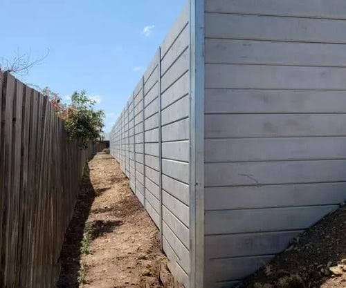 A brick wall with a metal corner and a blue sky in the background.