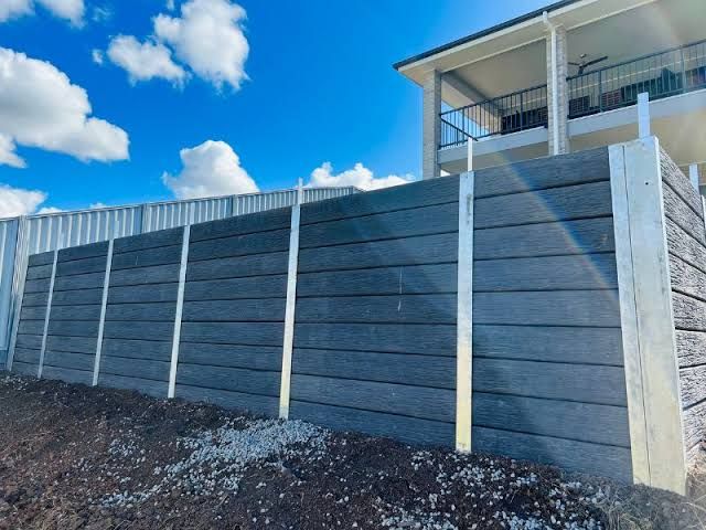 A wheelbarrow with a piece of wood on top of it.