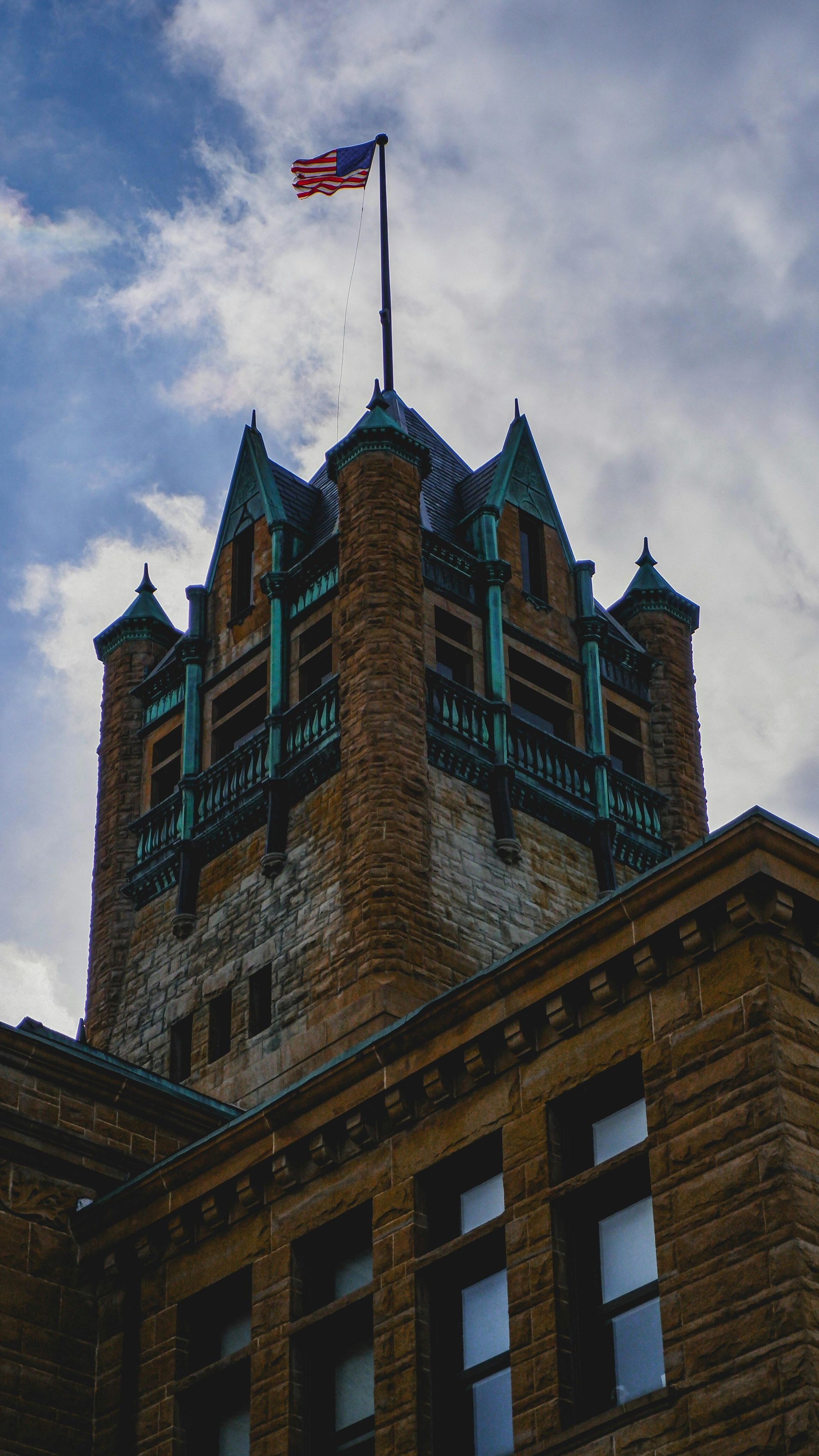 Stone building with oxidized copper roof  in Olathe, KS for commercial cleaning and janitorial services