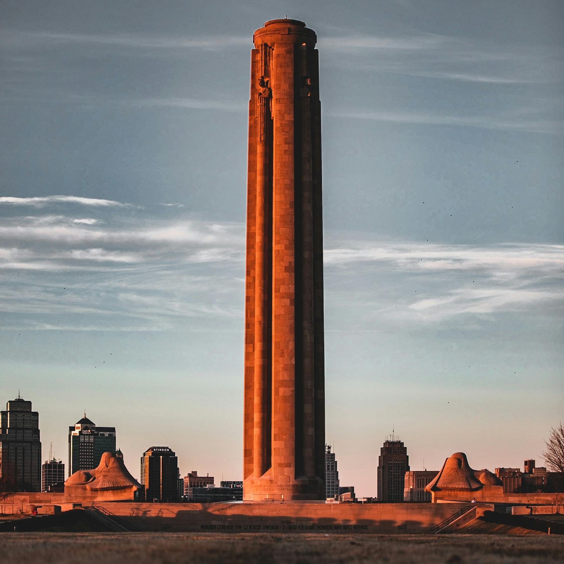 World War I memorial tower with city skyline backdrop in Missouri