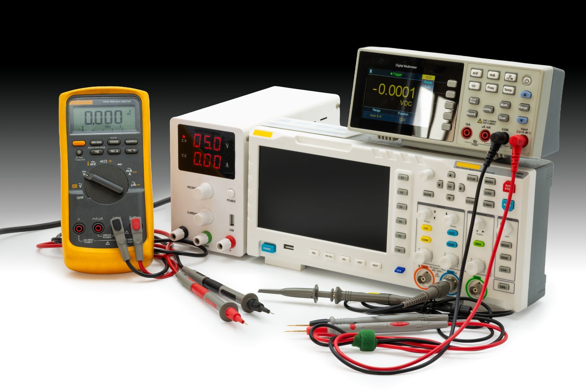 Electronics workbench with multimeter, digital oscilloscope, and power supply. Electronics workbench with multimeter, digital oscilloscope, and power supply.