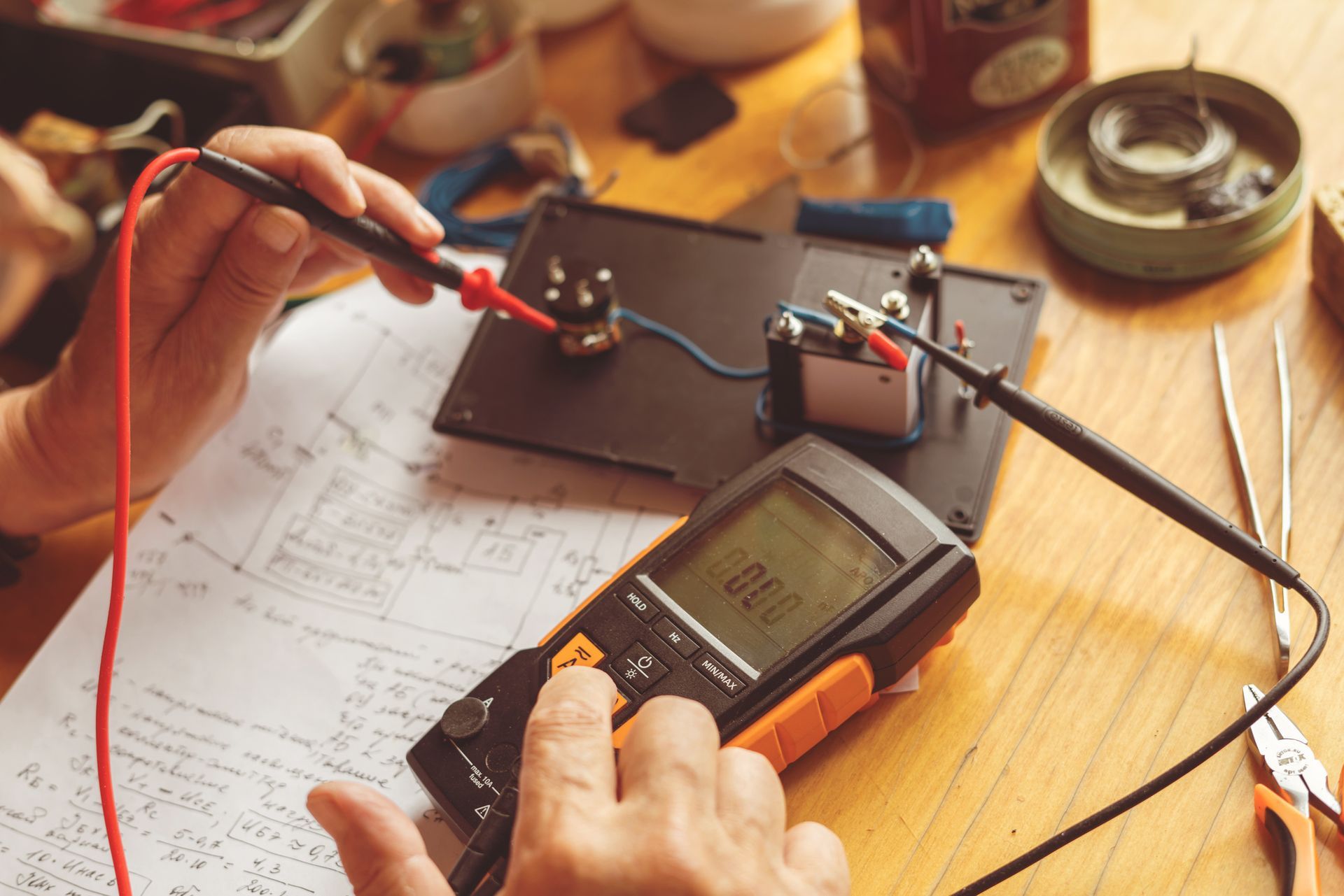 A Person Is Using a Multimeter to Test a Circuit.