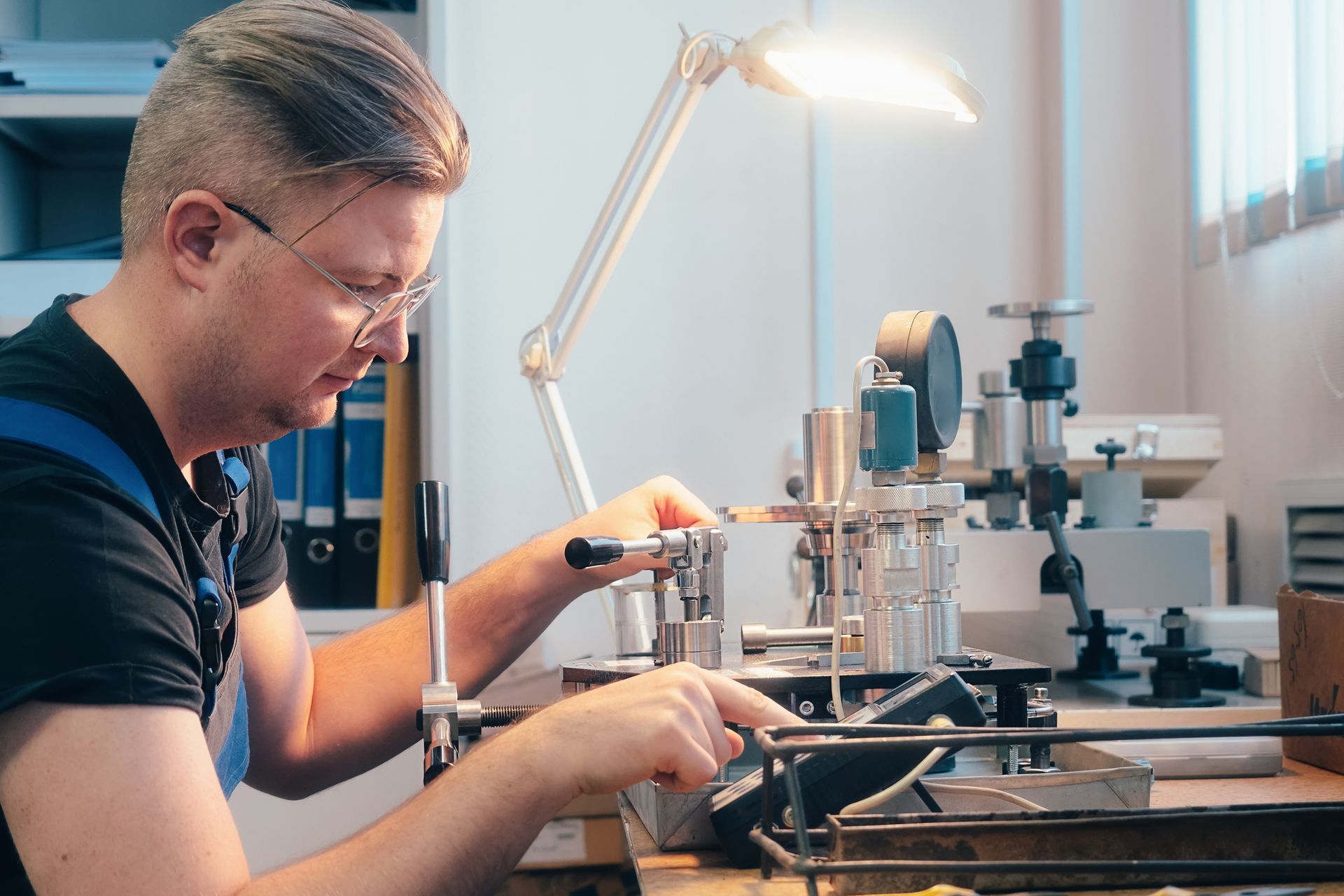 A technician performing precision calibration on pressure gauges and electronic sensors. A technician performing precision calibration on pressure gauges and electronic sensors.