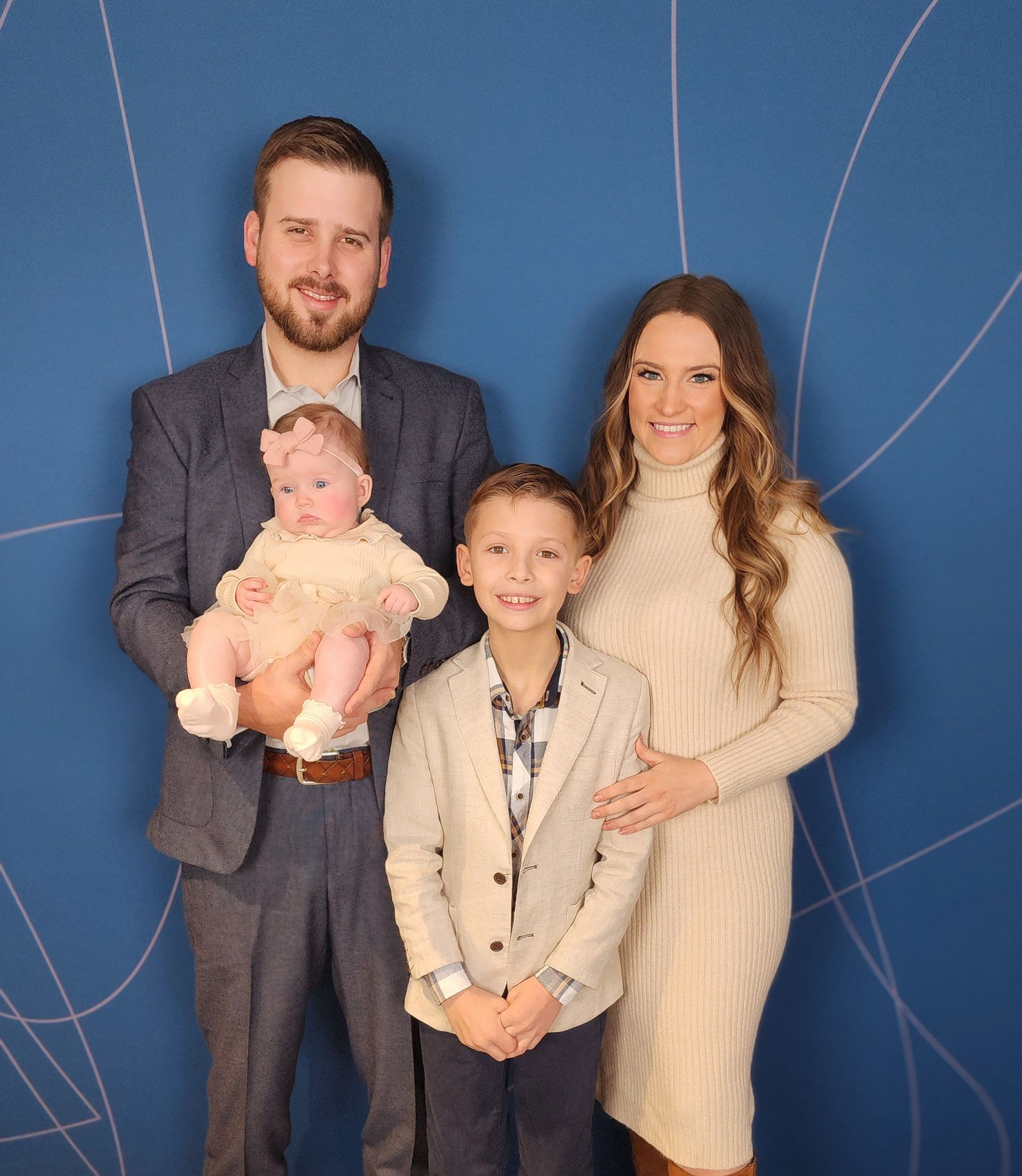 Backyard patio with light brown brick house, dark roof, and gray concrete.