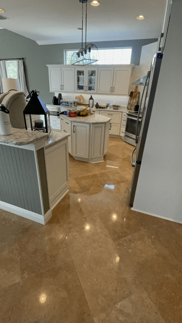 A man wearing a hat is laying bricks on a sidewalk.
