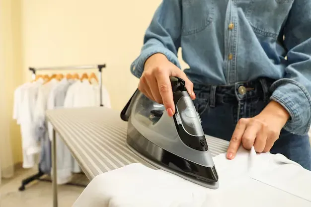 The sun is shining brightly on a lush green lawn in front of a house.