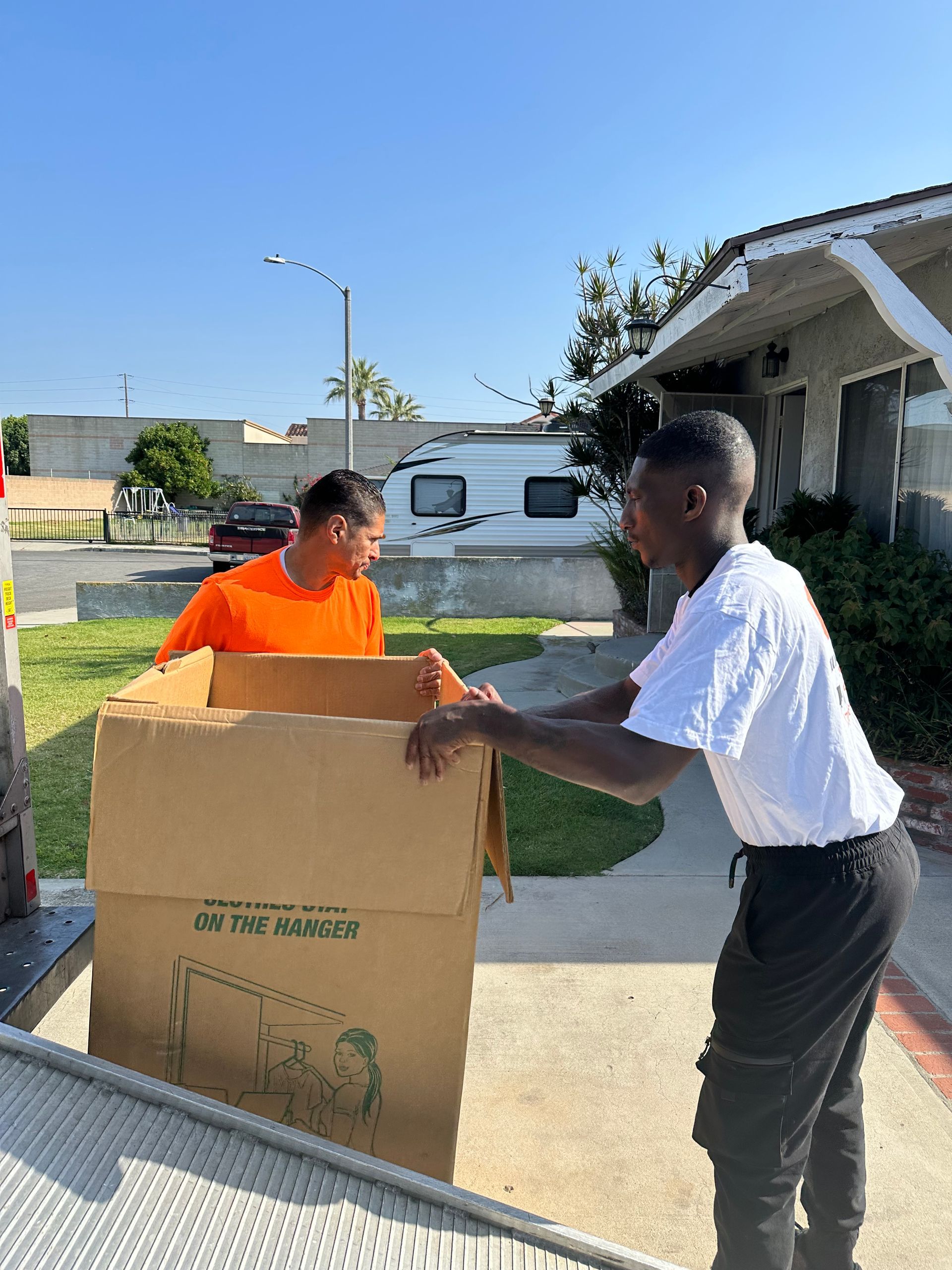 Happy Family Carrying Boxes | Las Vegas, NV | GXL Moving Company of Nevada