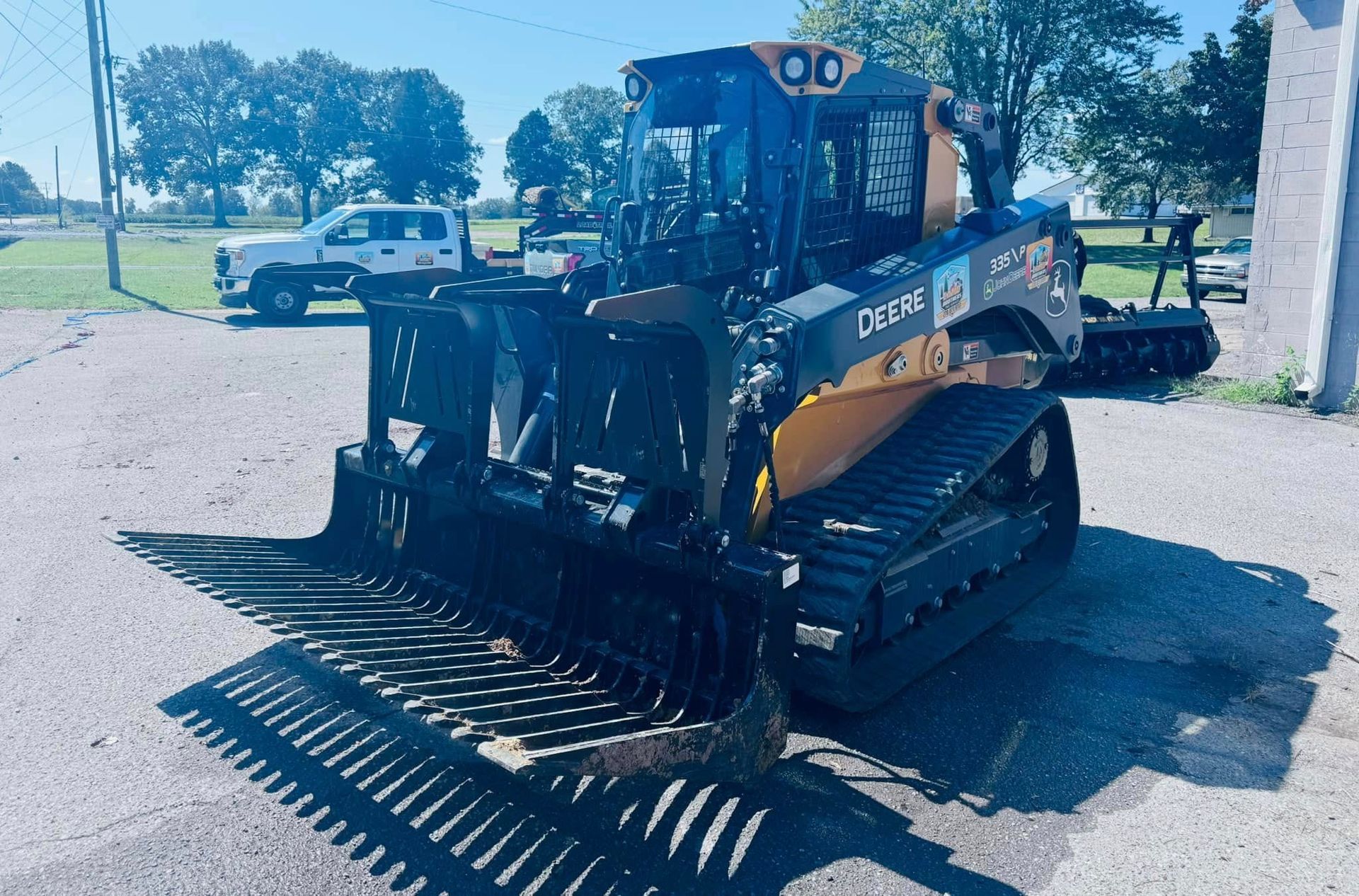 A black and yellow tractor is parked in a parking lot.