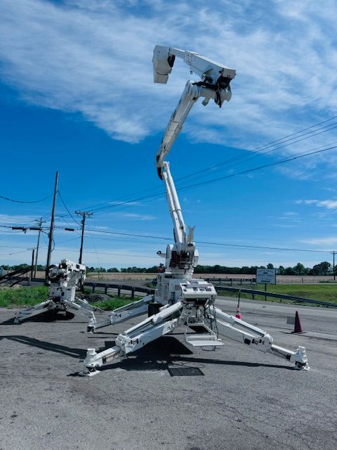 A white crane is parked on the side of the road