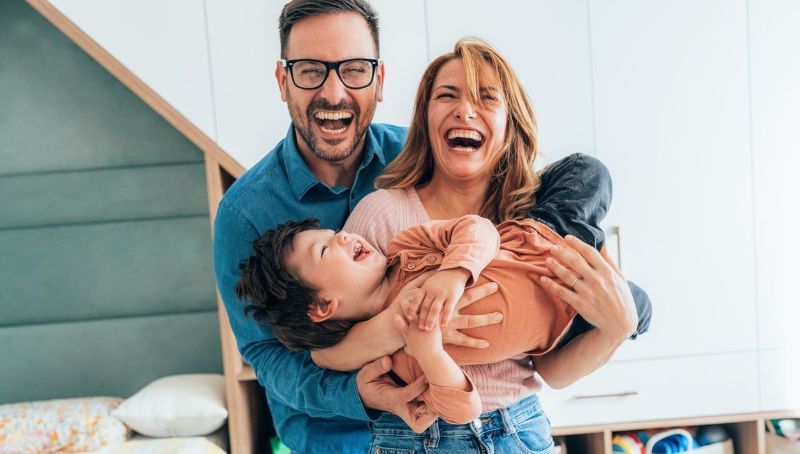 girl smiling with parents