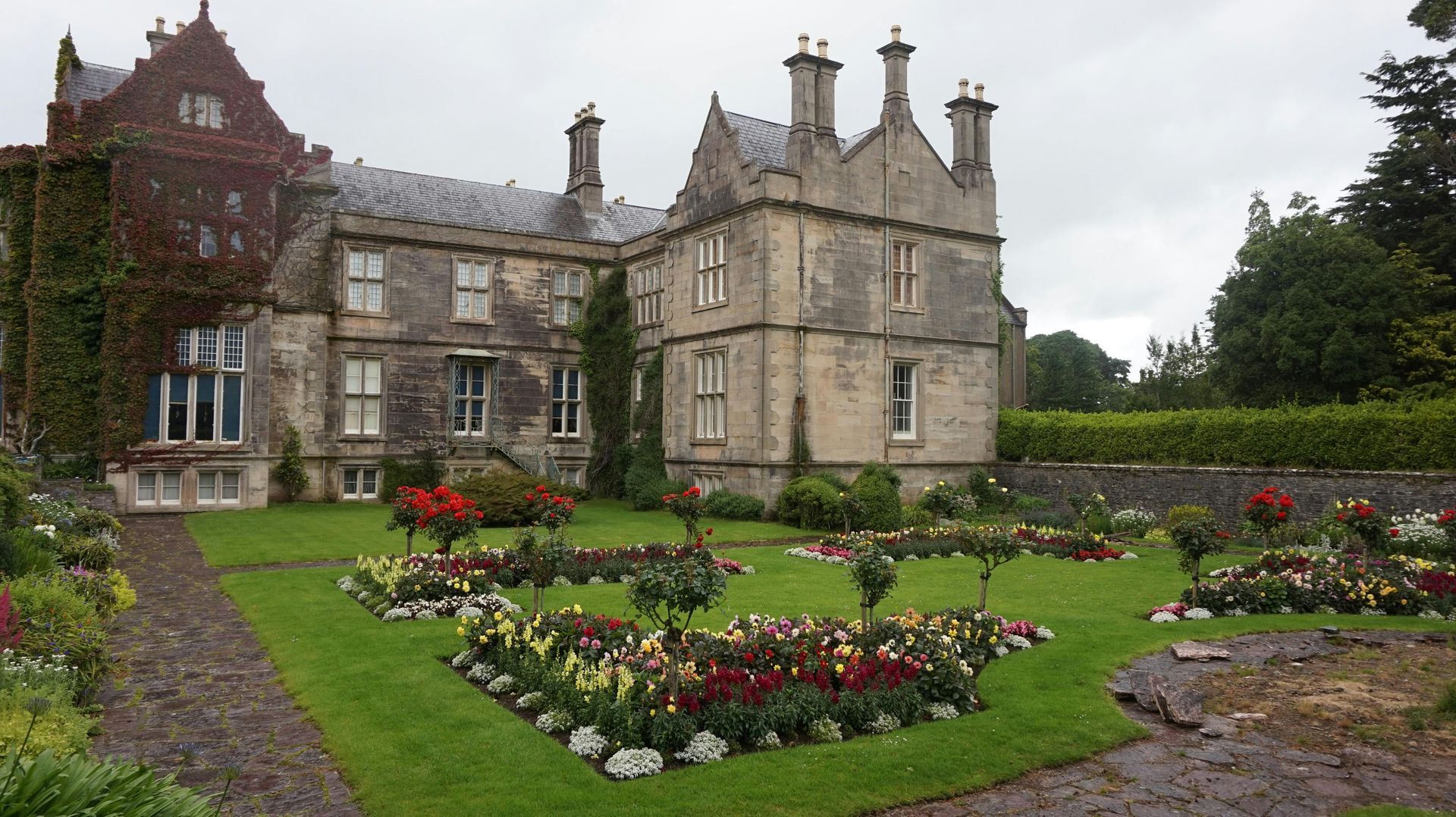 A large stone building with a heart shaped garden in front of it-Ireland