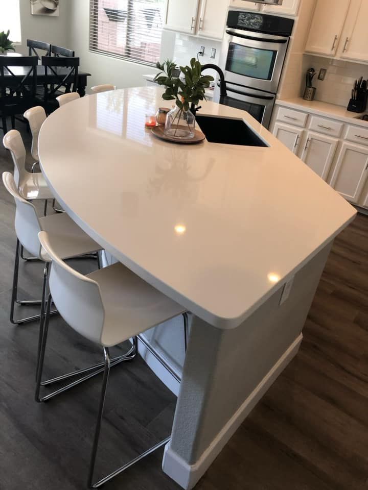 A kitchen with a large island and a sink