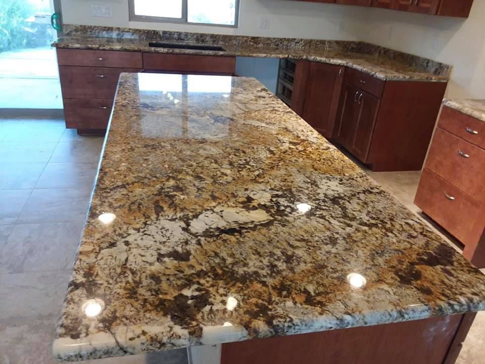 A kitchen with a large granite counter top